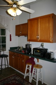 The sink side of the kitchen before it was remodeled. Notice the half counter top!
