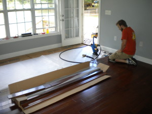 James laying hardwood flooring in master bedroom